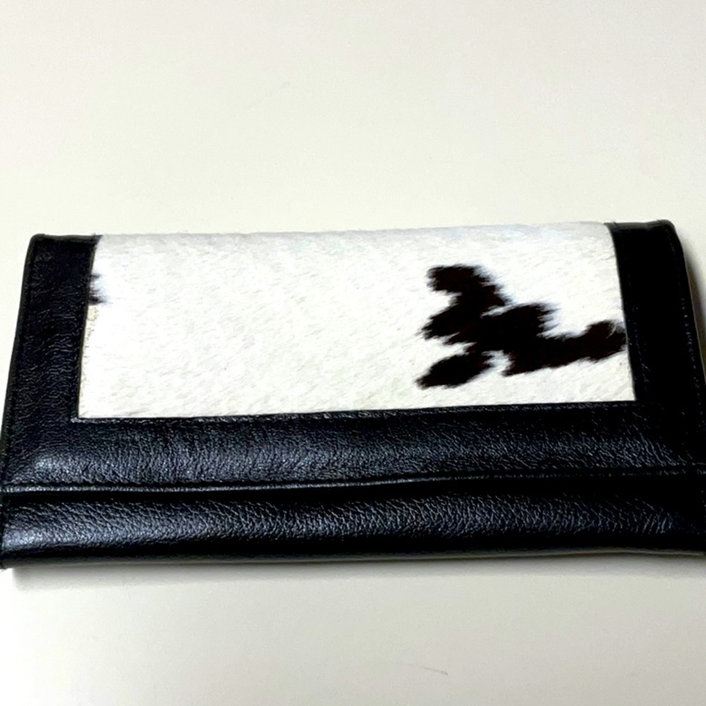 Pre-owned but never used.  cowhide and leather women’s wallet